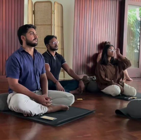 Yusuf and peers in seated breathwork practice